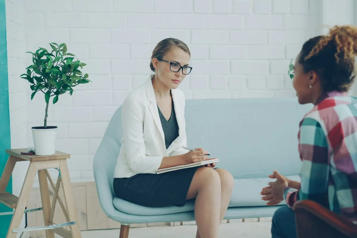 Counselor listening to a patient during a supportive behavioral health session