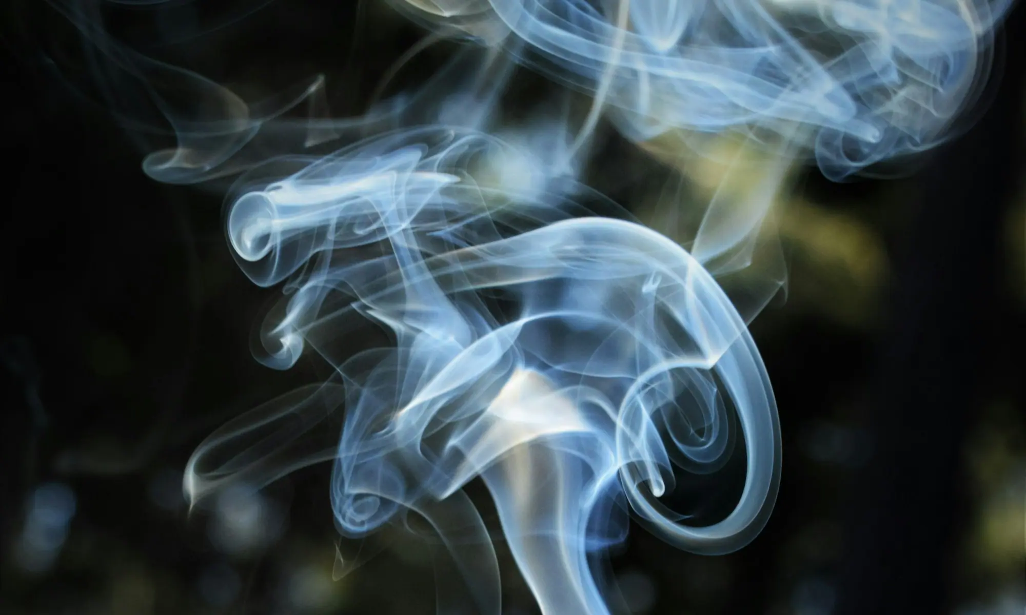 Wisps of smoke against a dark background — smoking cessation therapy in Modesto, CA