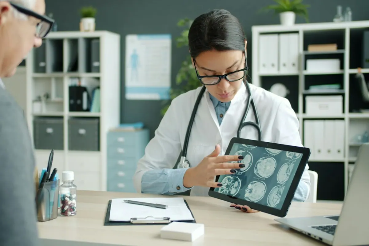 Physician reviewing scan results on a tablet with a patient during an addiction medicine evaluation