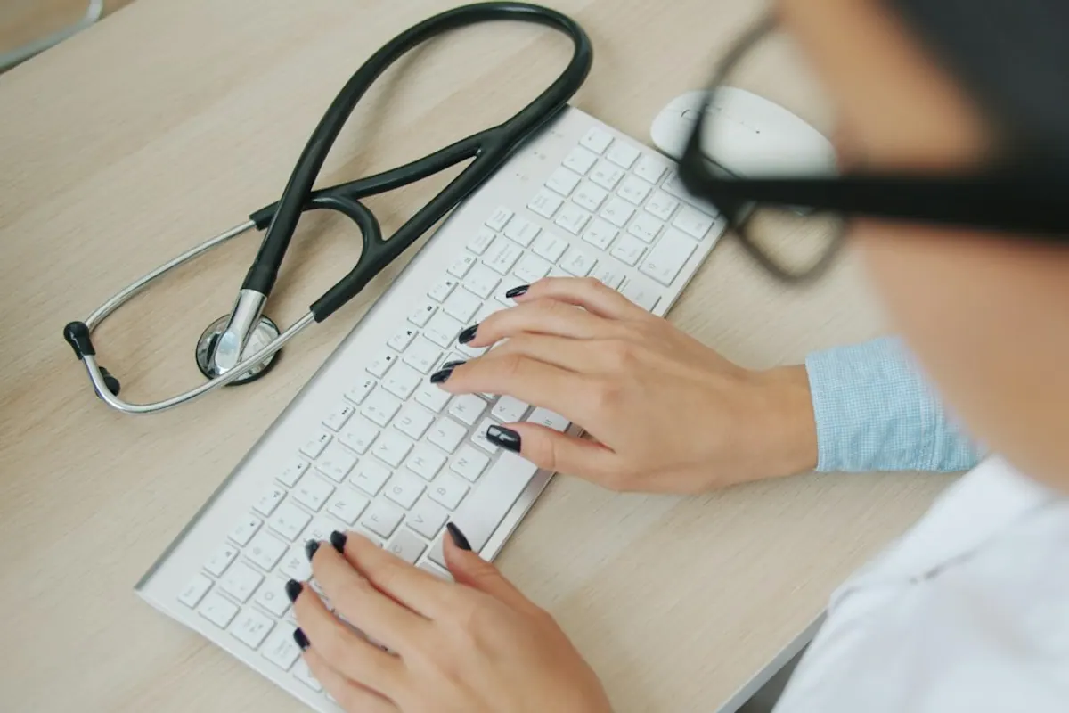 Clinician documenting symptom monitoring in a patient's medical record