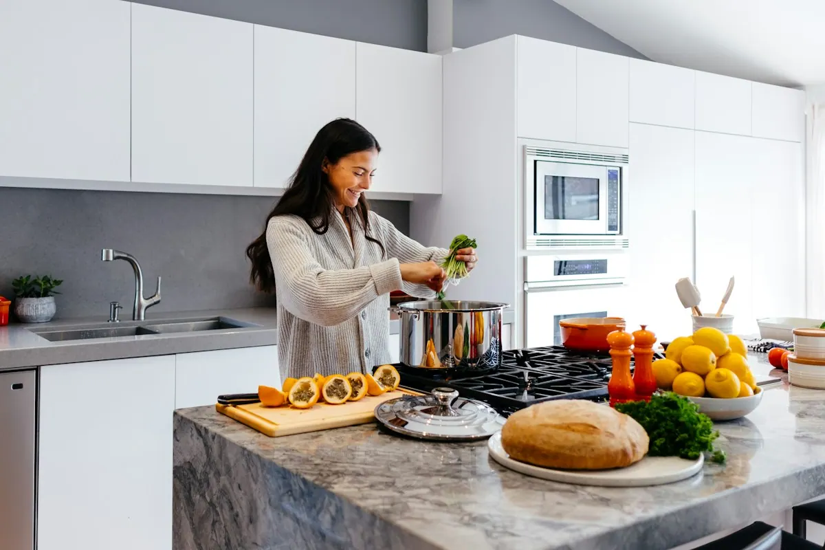 Woman preparing fresh food in a bright kitchen — managing food cravings and nutrition