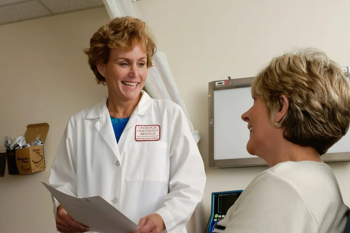 Smiling physician with a patient reviewing an outpatient alcohol treatment plan