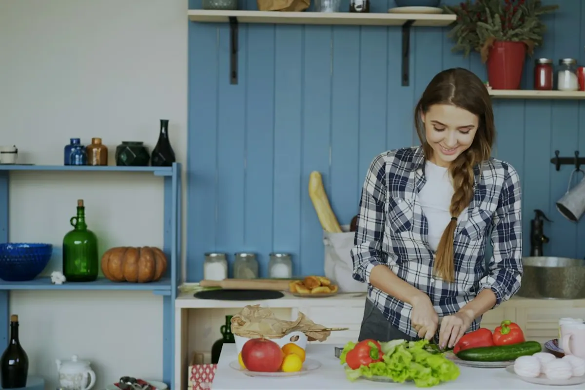 Woman chopping fresh vegetables — building sustainable nutrition habits